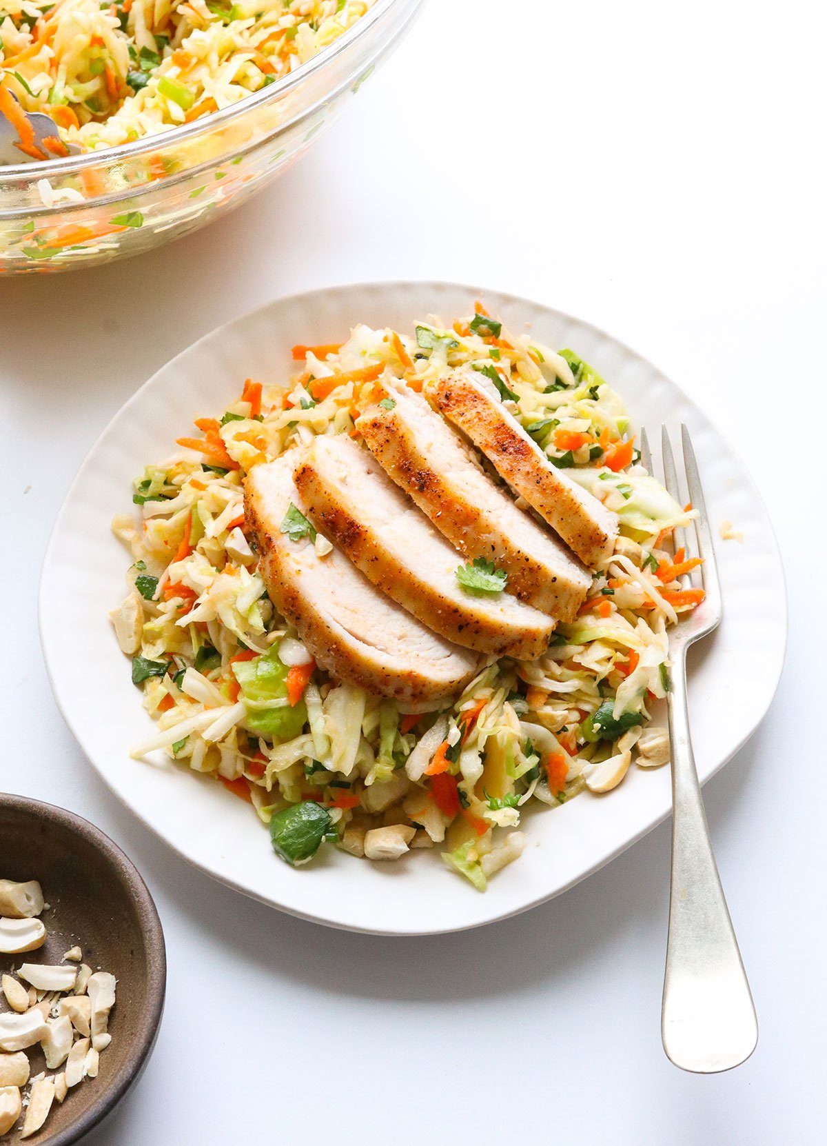 cabbage salad served with chicken on top.