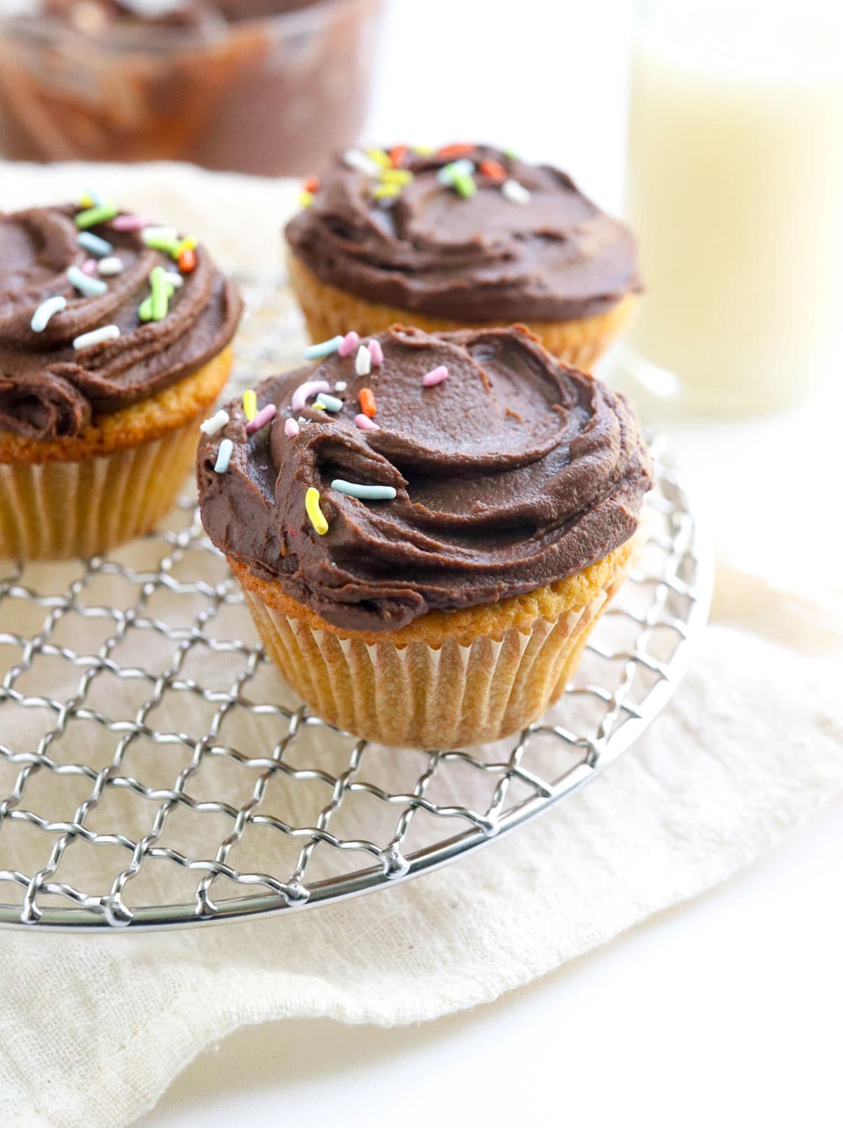 vanilla cupcakes with chocolate frosting and sprinkles