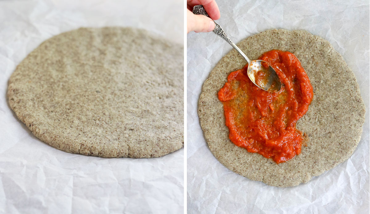 baked almond flour pizza crust with sauce added on top
