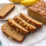 coconut flour banana bread sliced near a bunch of bananas.