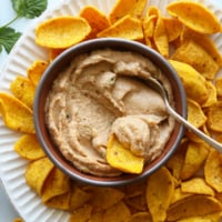 bean dip served with organic corn chips and fresh cilantro.