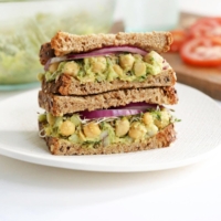 chickpea salad sandwich stacked on plate