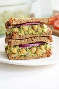 chickpea salad sandwich stacked on plate