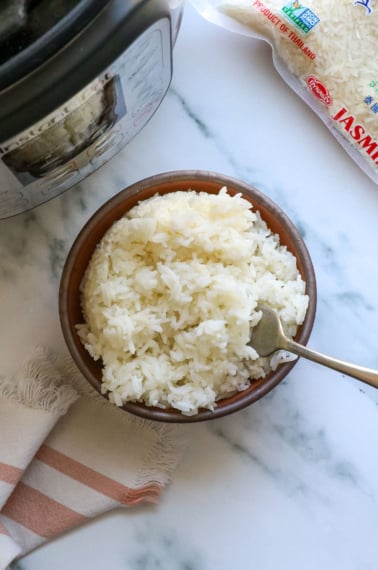 bowl of white rice near the Instant Pot with a fork.