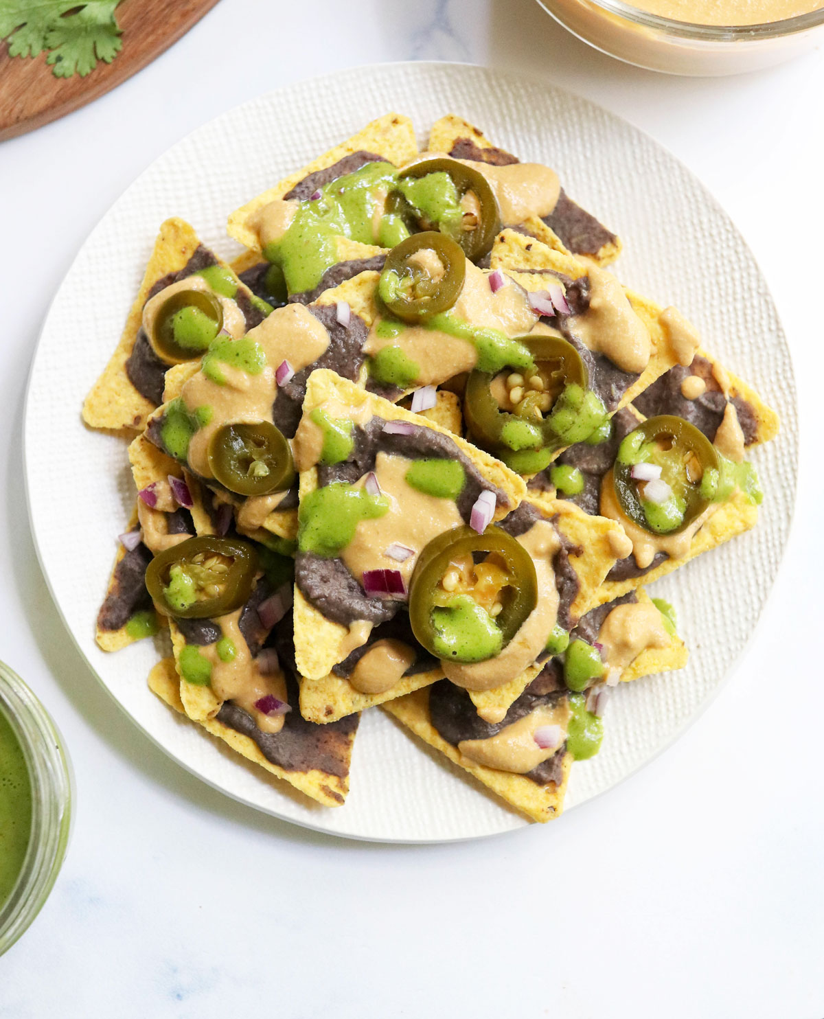 vegan nachos on a white plate overhead