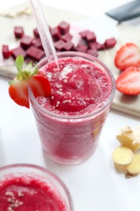 beet smoothie with strawberry on the side