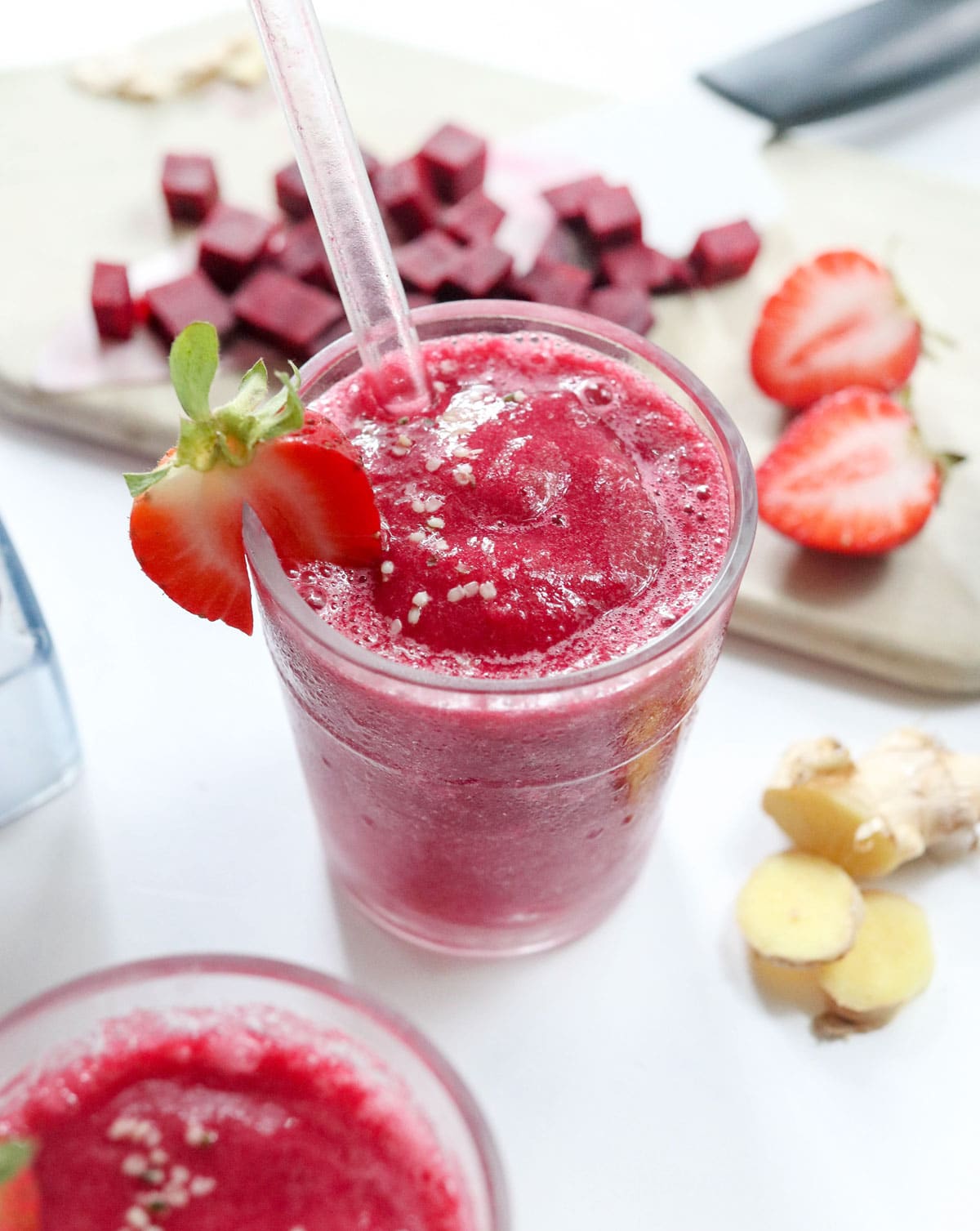 beet smoothie with strawberry on the side