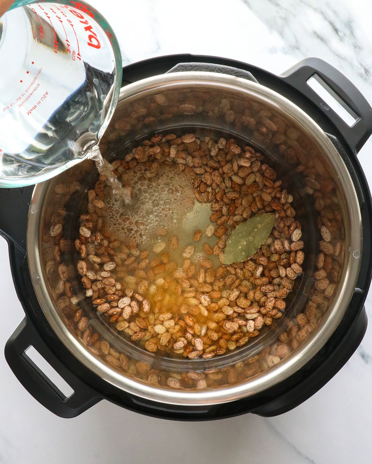 water added to dry beans and spices in the Instant pot.