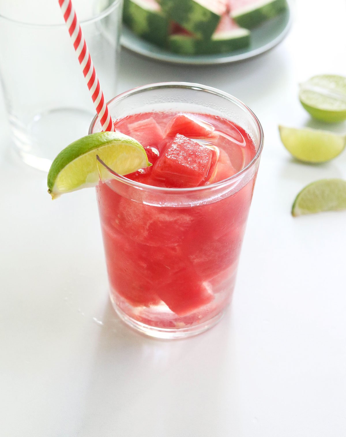 watermelon ice cubes in glass of water