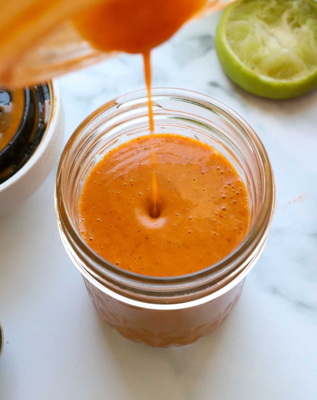 chipotle vinaigrette poured into a glass jar for storage.