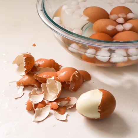 peeled hard boiled egg near a bowl of ice on my kitchen counter.