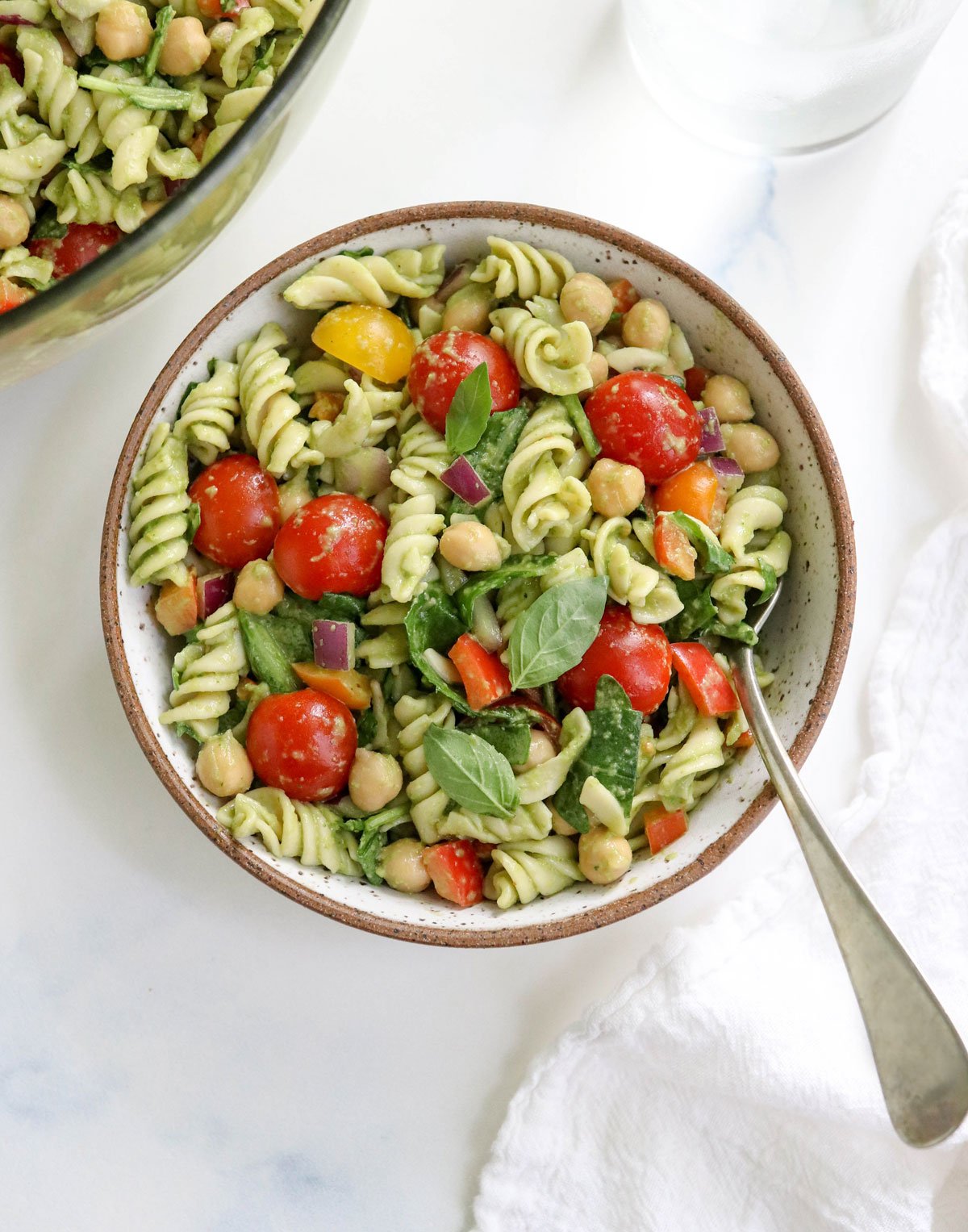 pesto pasta salad serving with a fork