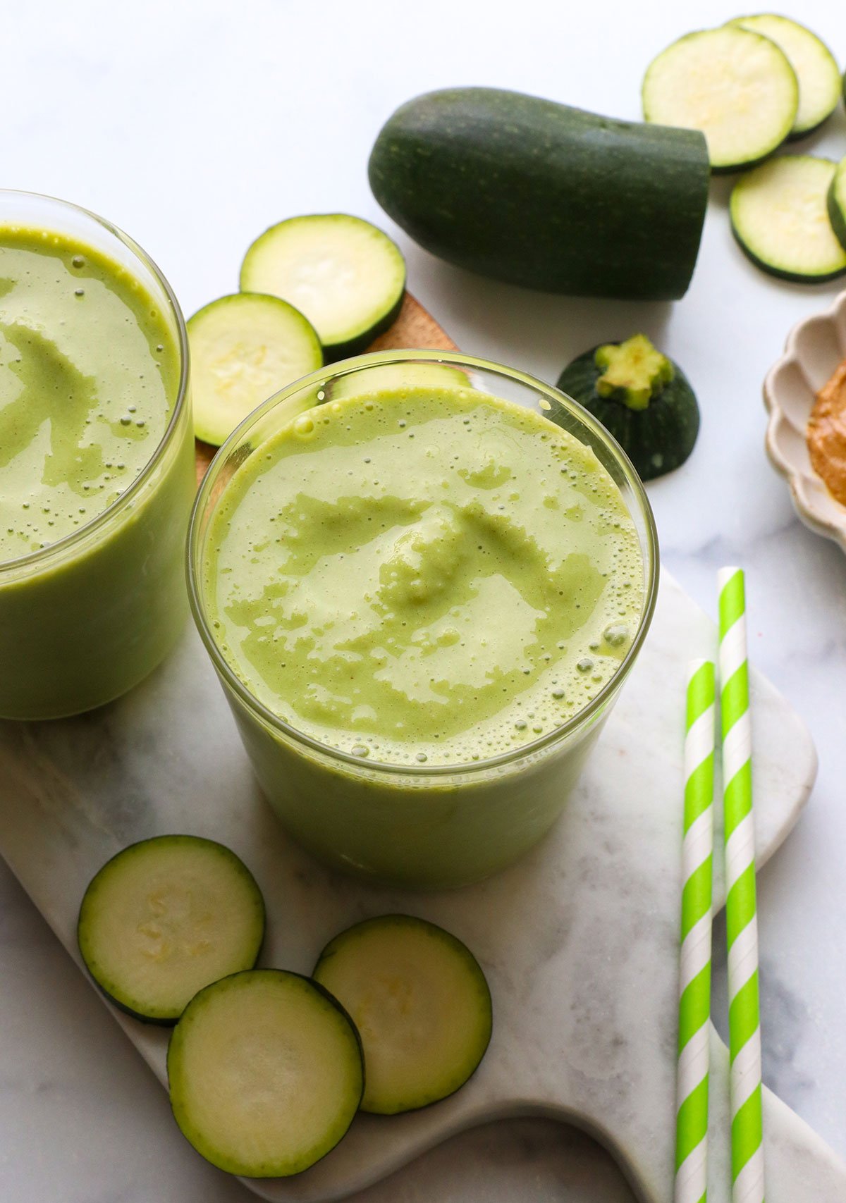 frosty zucchini smoothie in two glasses.