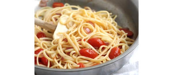 cooked pasta in pan with tomatoes