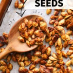 pumpkin seeds on a pan with wooden spoon labeled for pinterest.