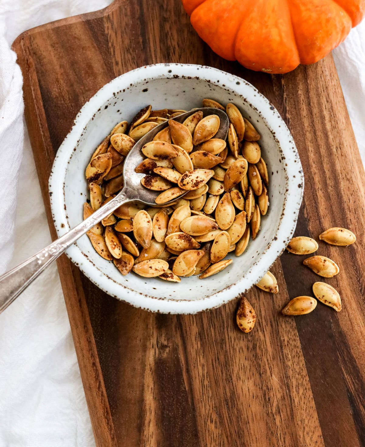 roasted pumpkin seeds in a white bowl