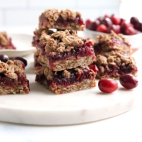cranberry bars stacked on marble board
