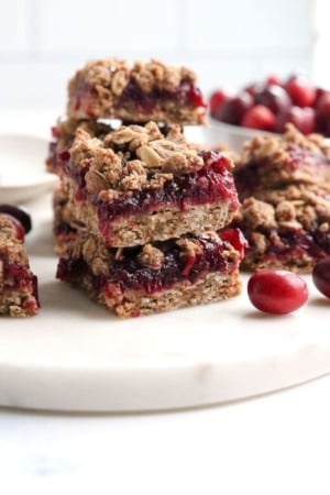cranberry bars stacked on marble board