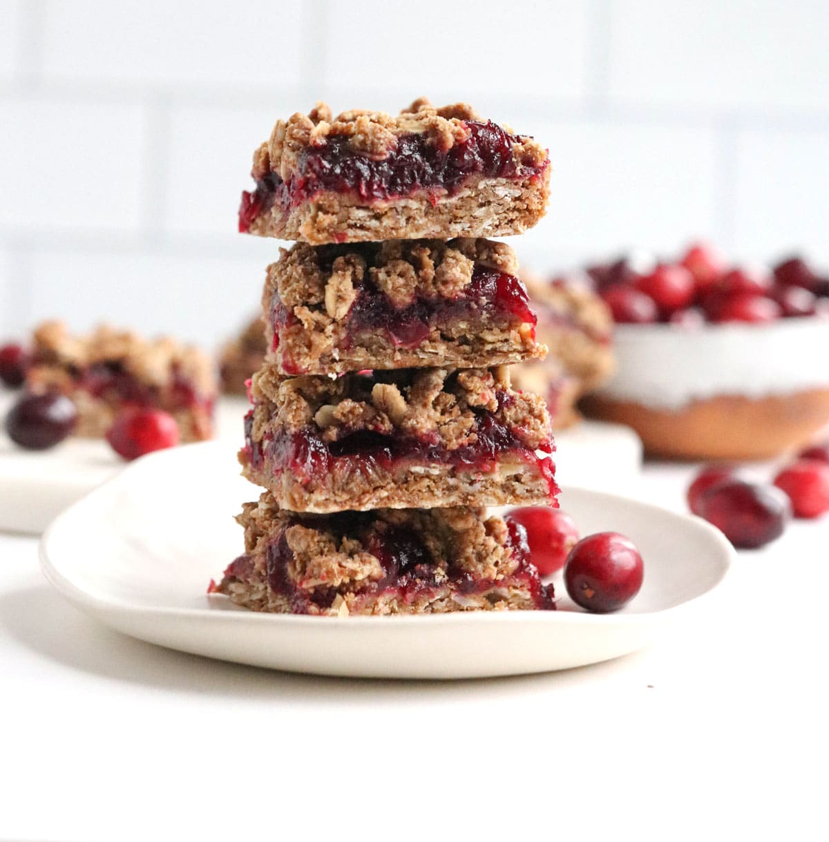 cranberry bars stacked on white plate