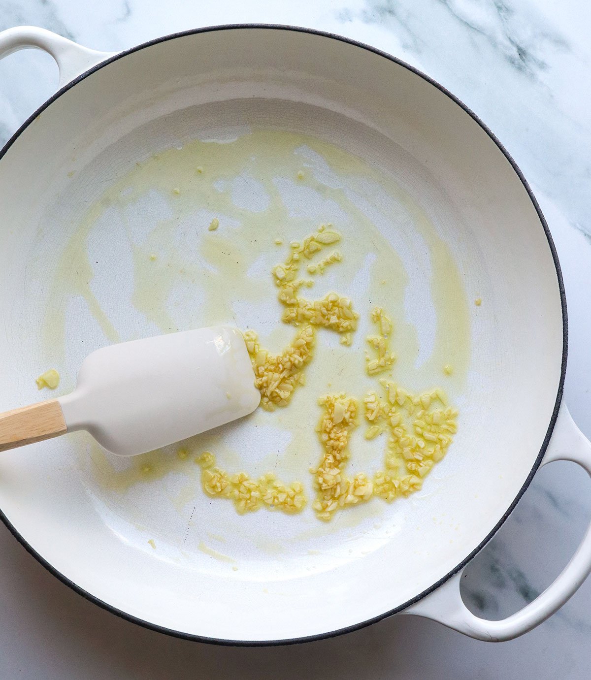 garlic sauteed briefly in olive oil in a large white skillet.  - 5