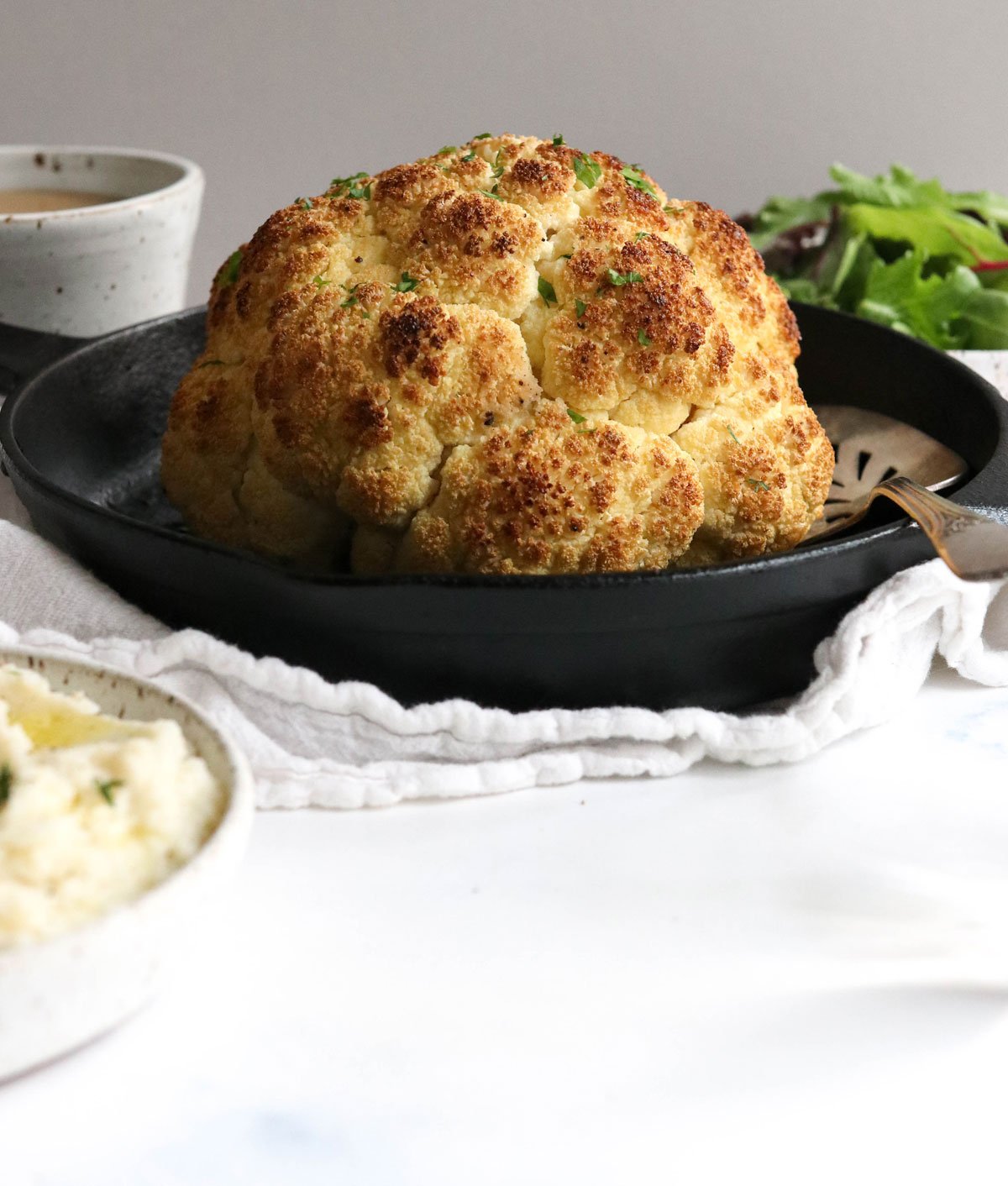 whole roasted cauliflower in pan