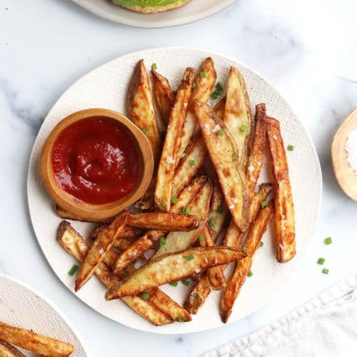 air fryer fries on white plate with ketchup