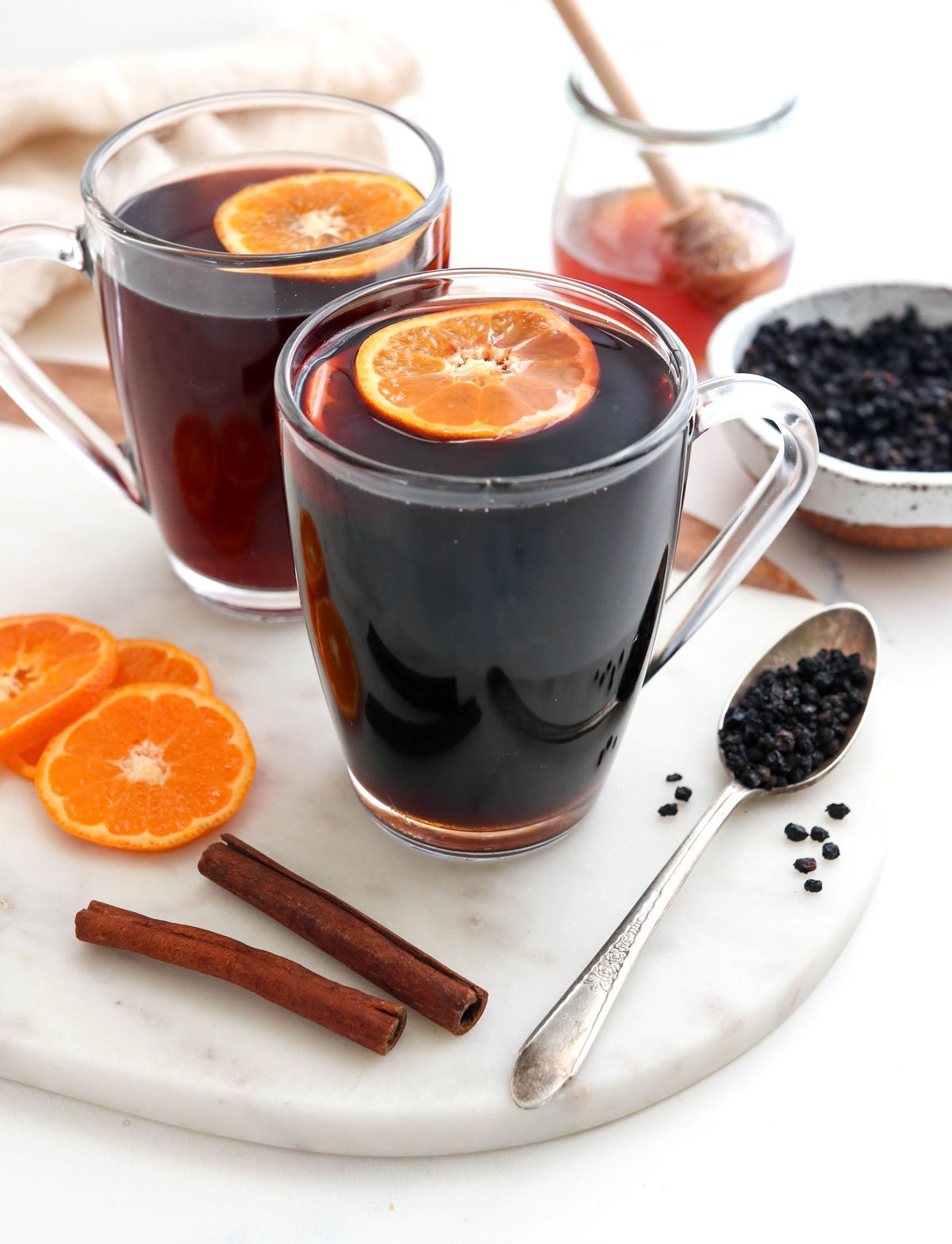 orange slices floating in elderberry tea