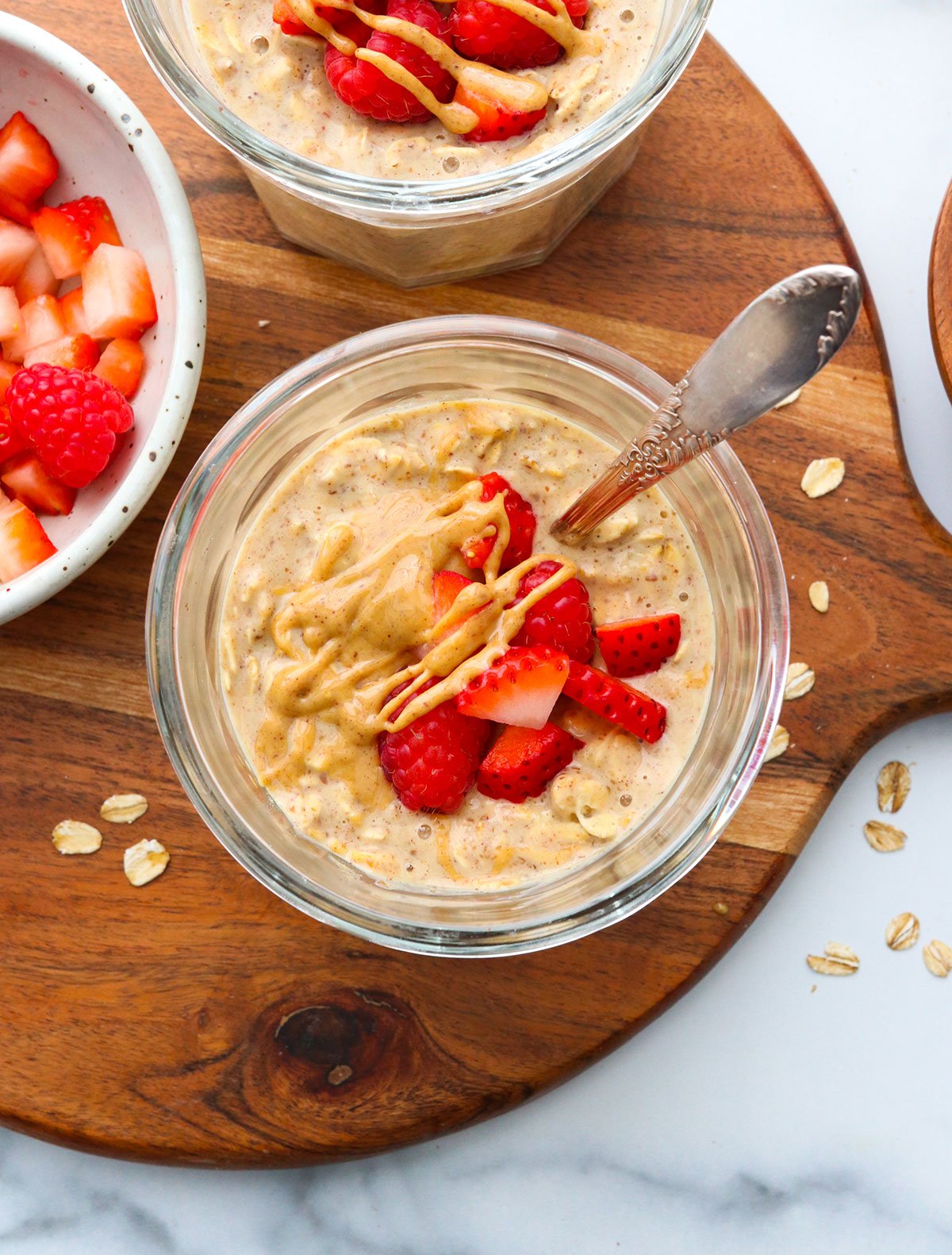 strawberries served on top of peanut butter overnight oats.