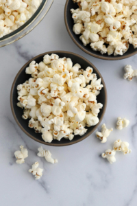 popcorn in two black bowls
