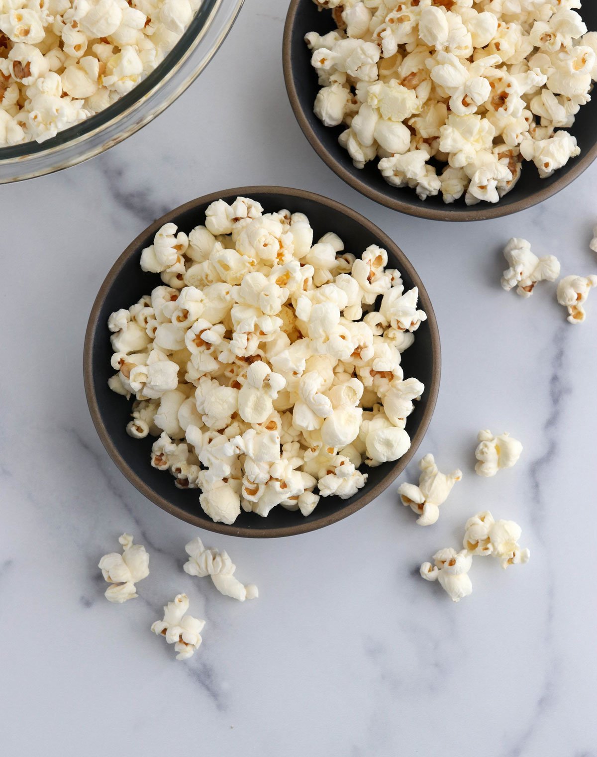 popcorn in two black bowls