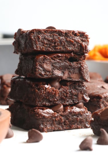 sweet potato brownies stacked on parchment paper.