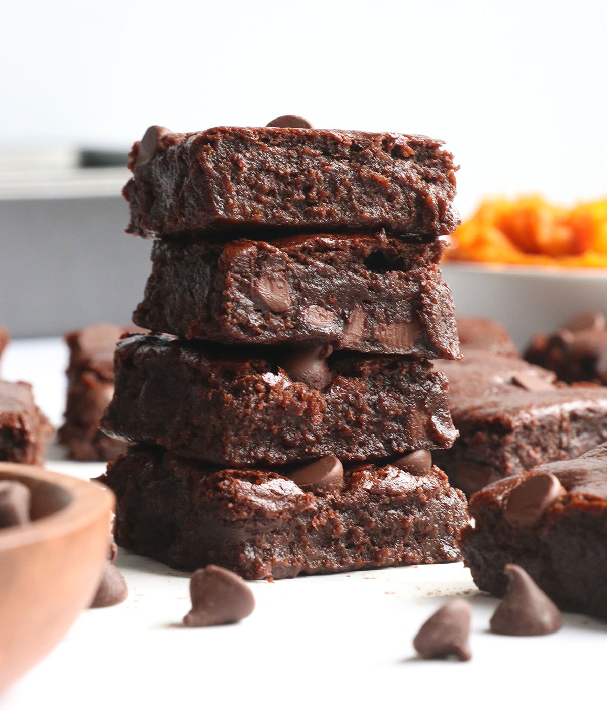 sweet potato brownies stacked on parchment paper. 