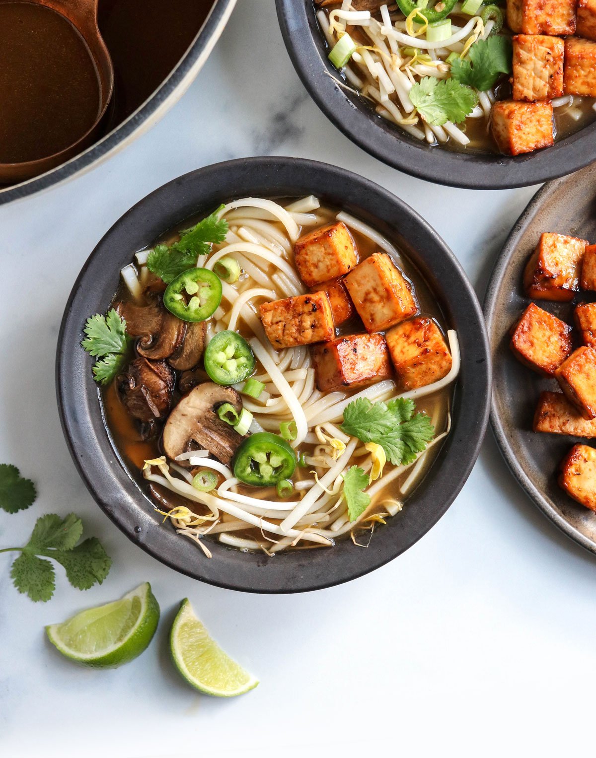 vegan pho in black bowls