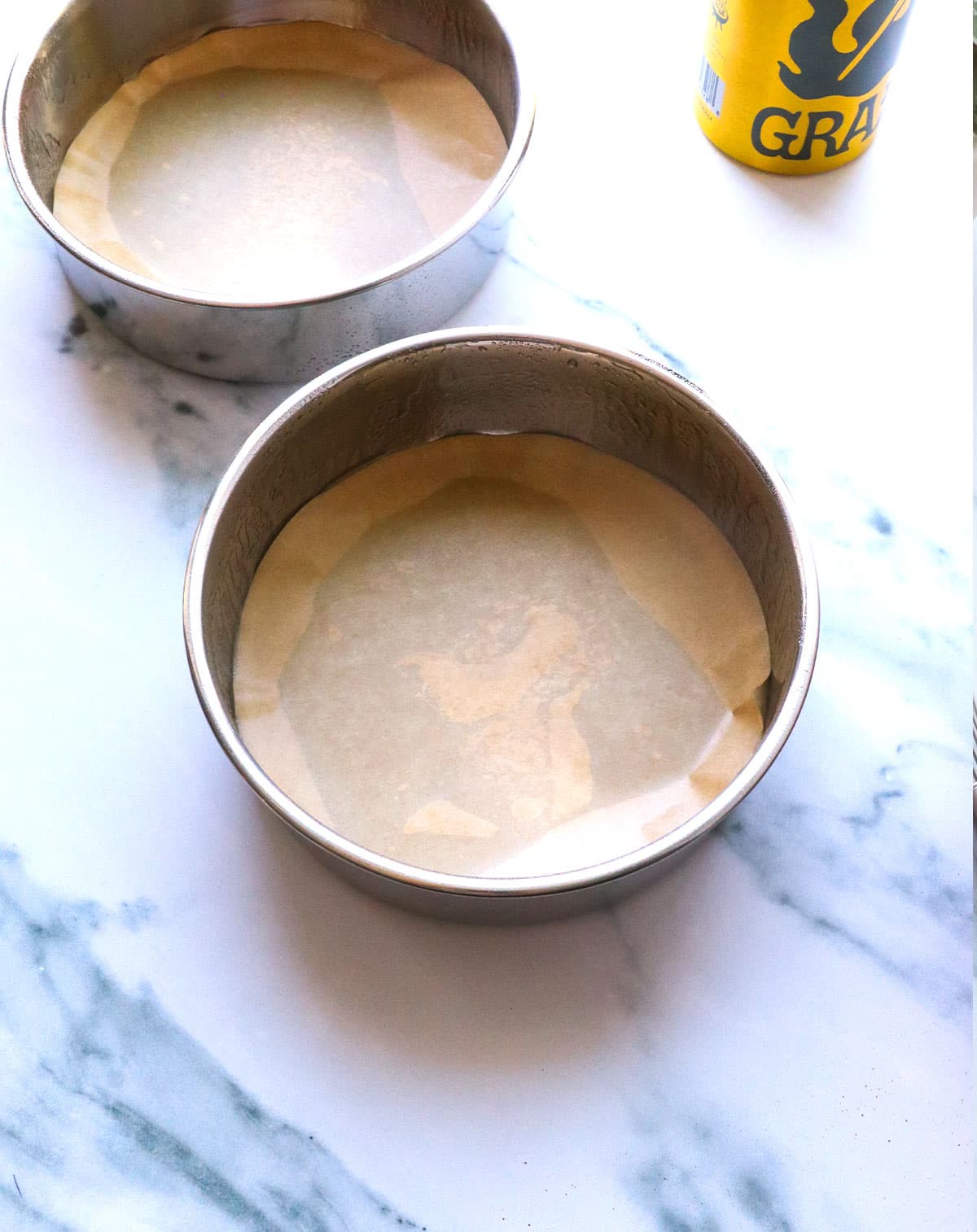 two 6 inch pans greased with parchment paper in the bottom.