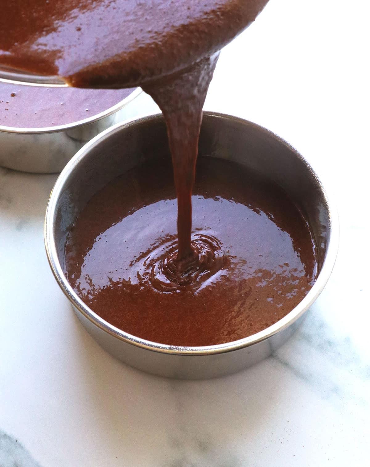 chocolate almond flour cake batter poured into a 6-inch pan.