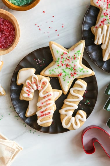 almond flour sugar cookies with sprinkles on black plate.