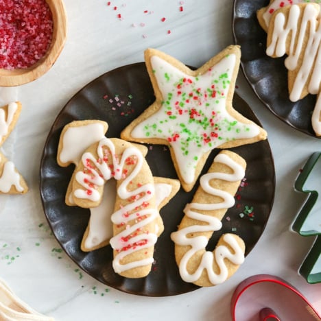almond flour sugar cookies with sprinkles on black plate.