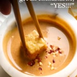 baked tofu dipped in peanut sauce and labeled for Pinterest.