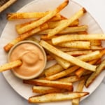homemade fries served on a white plate with special sauce.