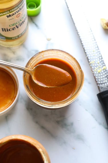 peanut dressing recipe in a jar with a spoon.