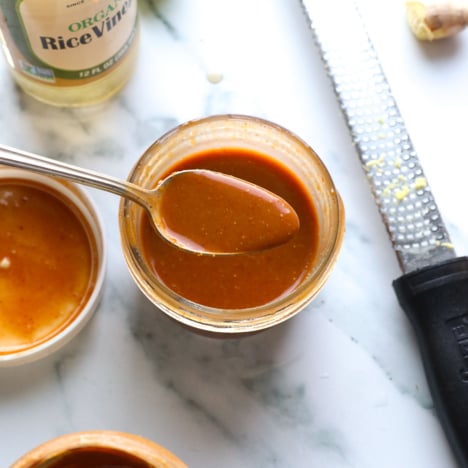 peanut dressing recipe in a jar with a spoon.