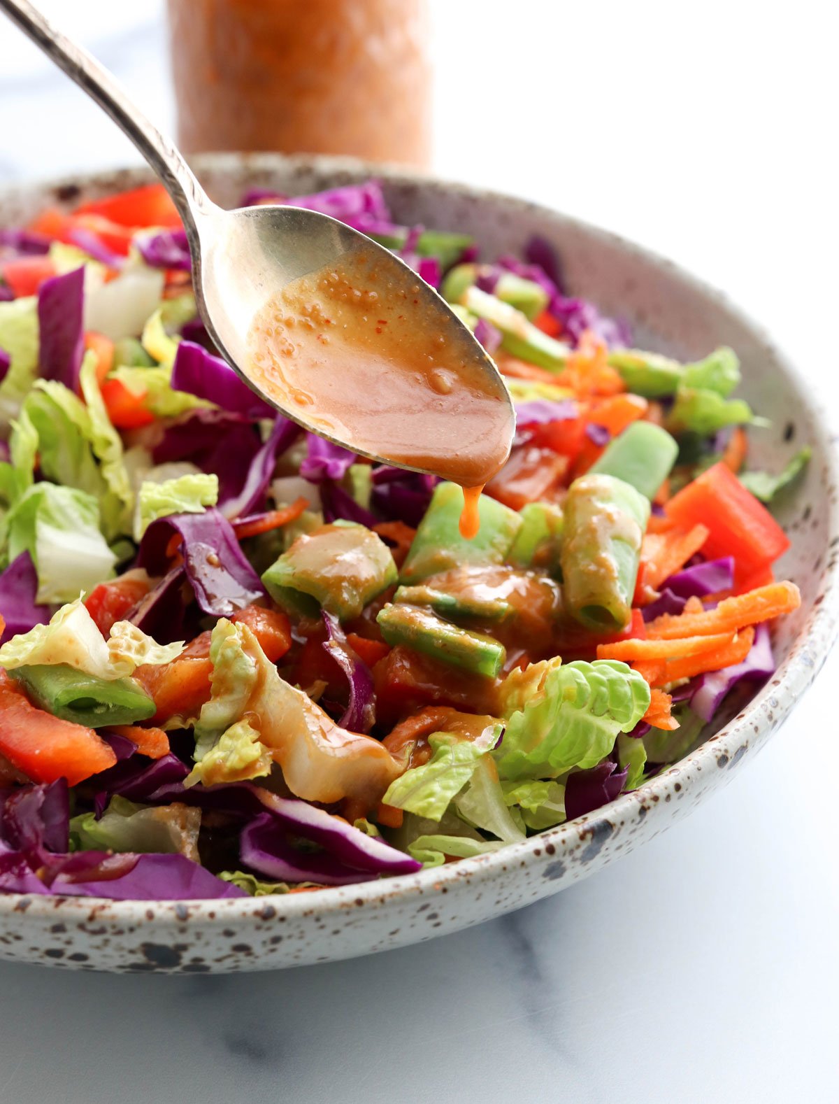 peanut dressing poured over salad