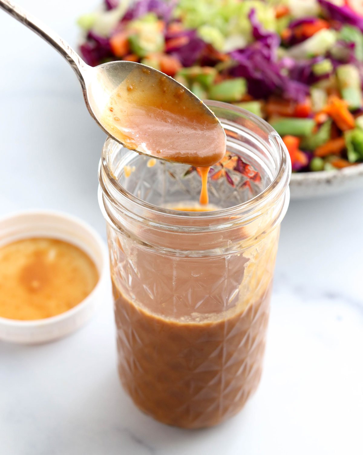 peanut salad dressing in jar on spoon