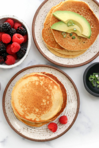 chickpea pancakes topped with avocado and berries