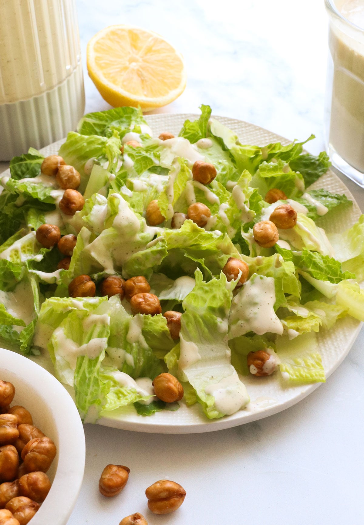 vegan caesar dressing made with miso over a plate of lettuce.