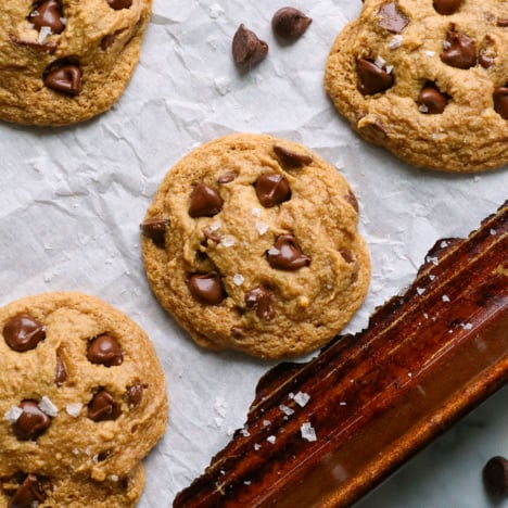 almond flour cookies topped with salt on a pan.