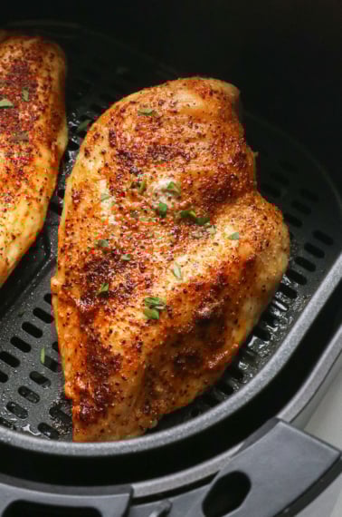 close up of chicken in the air fryer.