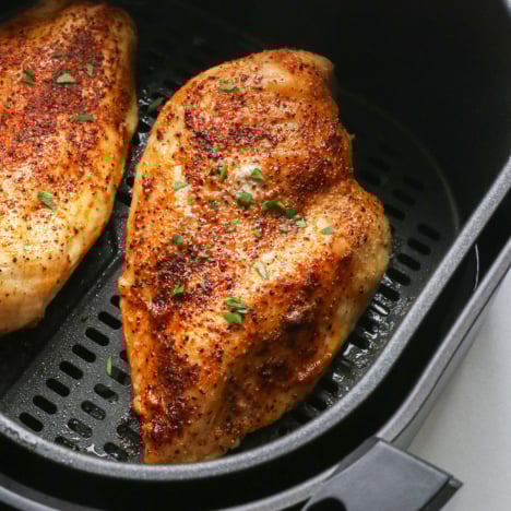 close up of chicken in the air fryer.