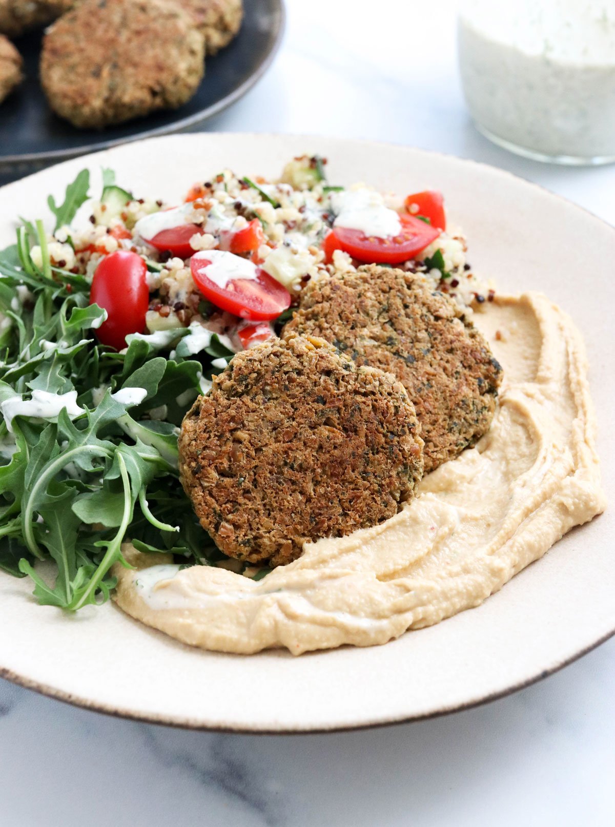 baked falafel on plate with hummus