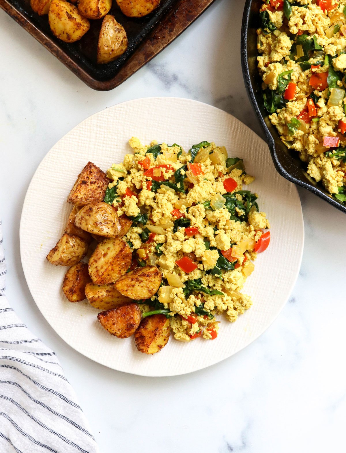 tofu scramble on plate with potatoes